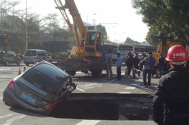 Huge sinkhole swallows car while driver makes