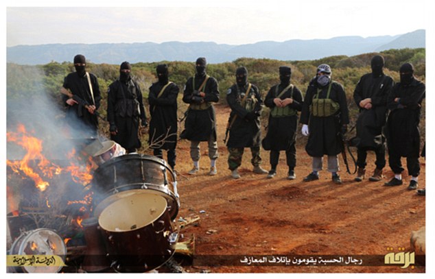 ISIS militants burn western musical instrumen
