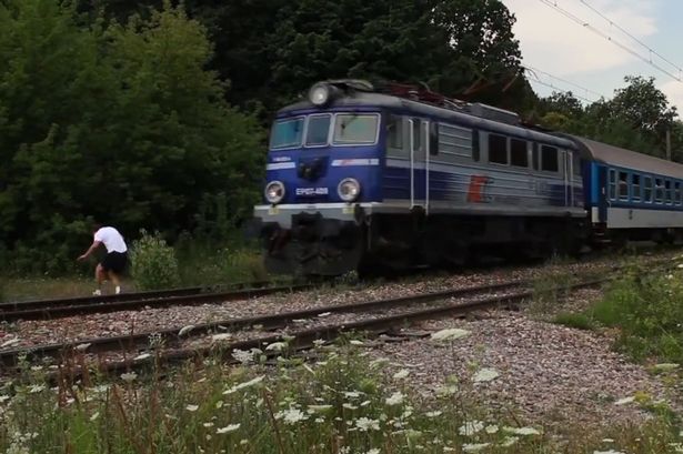 daredevil-gambles-with-death-as-he-jumps-in-front-of-a-fast-train